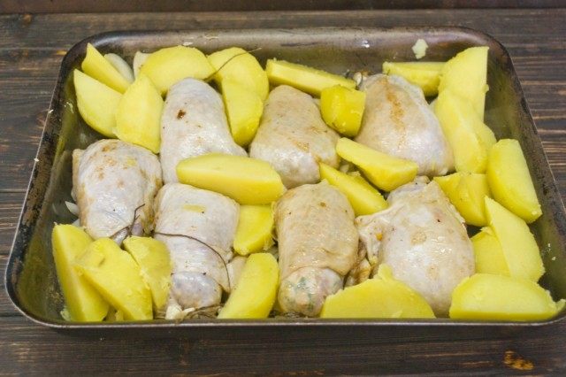 На противень выкладываем котлеты, лук и картофель