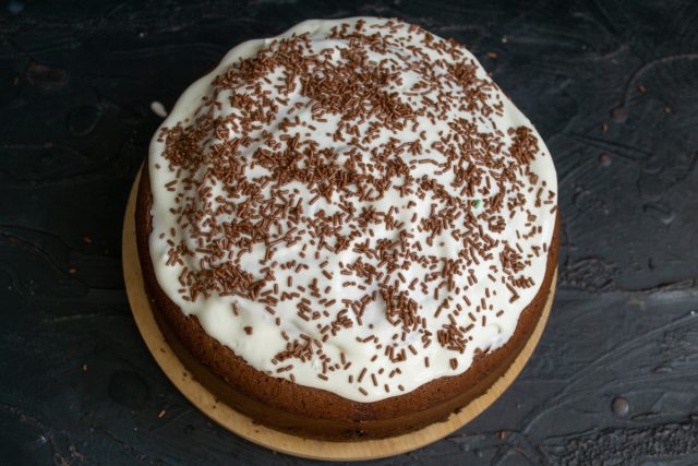 Поливаем сверху оставшимся сметанным кремом, посыпаем шоколадной вермишелью и оставляем торт «Норка крота» в холодильнике на 10-12 часов.