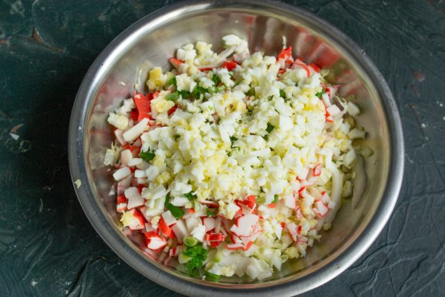 Измельчаем заранее сваренные вкрутую куриные яйца ножом или натираем их на крупной терке. Добавляем яичную крошку в салатник Измельчаем заранее сваренные вкрутую куриные яйца ножом или натираем их на крупной терке. Добавляем яичную крошку в салатник