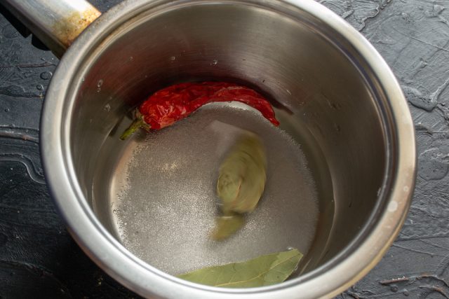 Приготовление маринада с чили и лавровым листом в кастрюле