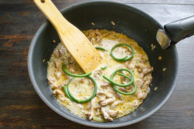 Кладем в сковороду скрученные кольцами верхушки чесночных стрелок, закрываем крышкой и томим мясо на слабом огне до мягкости в течение двадцати пяти или сорока минут. Кладем в сковороду скрученные кольцами верхушки чесночных стрелок, закрываем крышкой и томим мясо на слабом огне до мягкости в течение двадцати пяти или сорока минут.