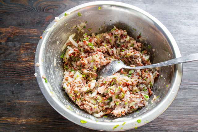 Тщательно приправляем подготовленную мясную массу, аккуратно добавляя соль по своему вкусу и обязательно посыпая свежемолотым черным перцем для легкой пикантности.